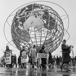 CORE picketers march in the shadow of the Unisphere at the 1964 World's Fair.